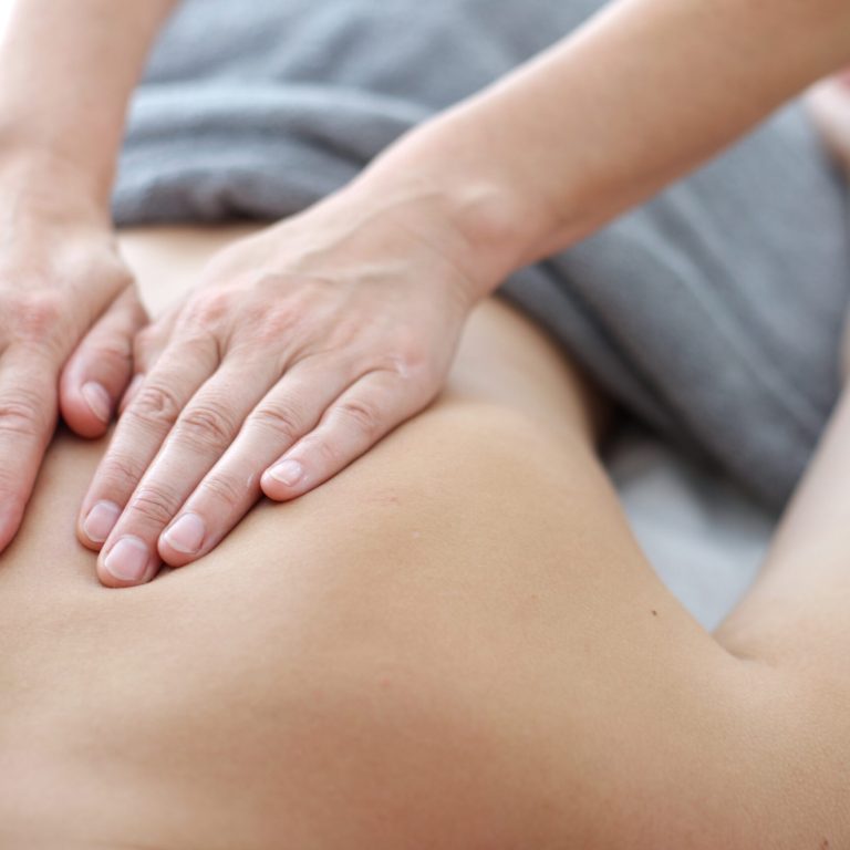 Close up of back massage procedure in spa salon